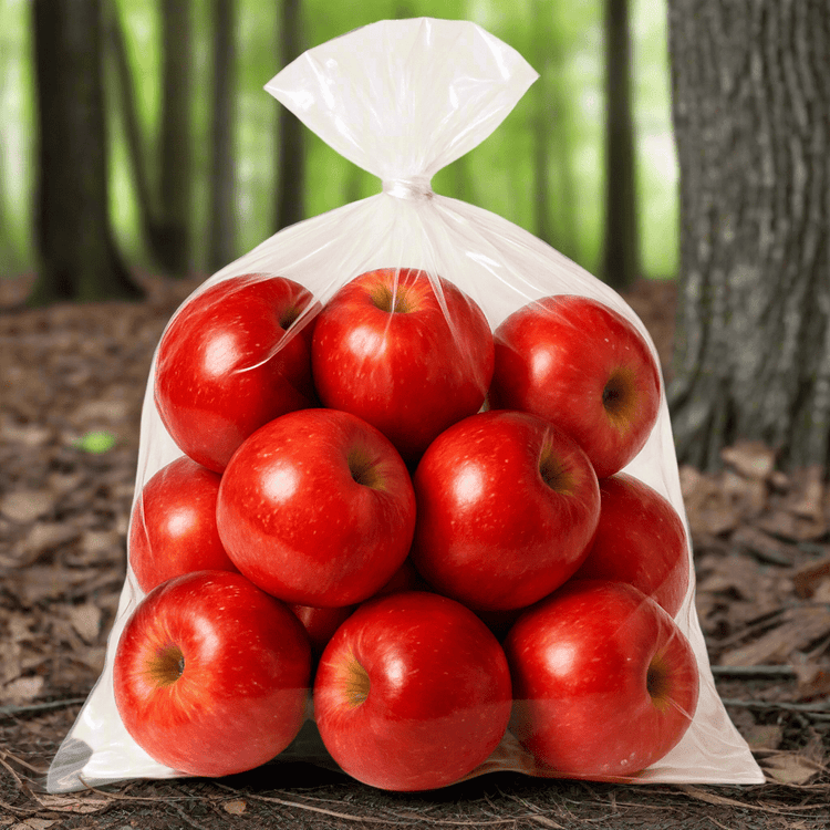 a tied plastic bag of red apples